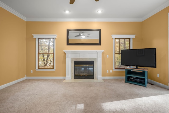 unfurnished living room with light carpet, a wealth of natural light, ornamental molding, and ceiling fan