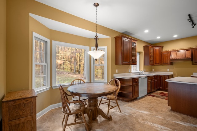 kitchen featuring pendant lighting, stainless steel dishwasher, and light tile patterned flooring