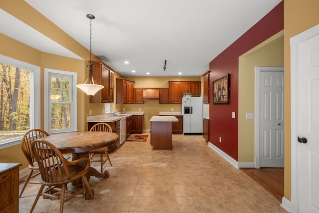 dining area with plenty of natural light, light wood-type flooring, and sink