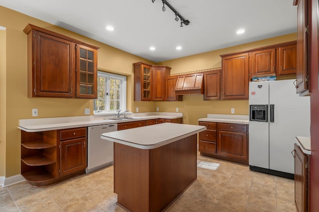 kitchen with a center island, sink, rail lighting, stainless steel dishwasher, and white fridge with ice dispenser