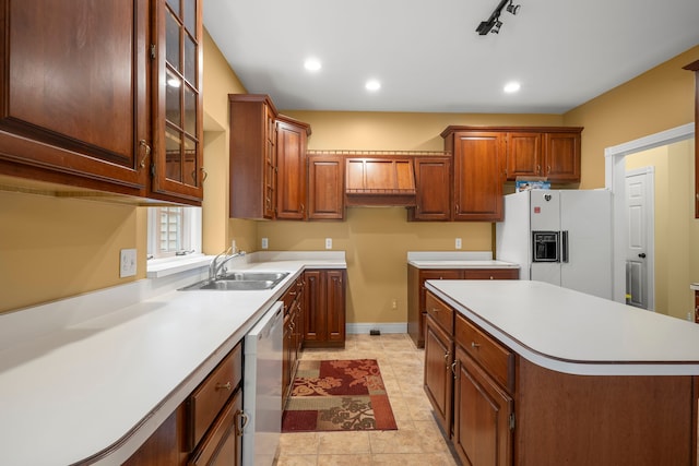 kitchen with dishwasher, sink, white fridge with ice dispenser, light tile patterned floors, and a kitchen island