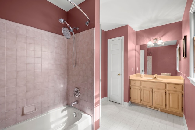 bathroom featuring tile patterned flooring, vanity, and tiled shower / bath