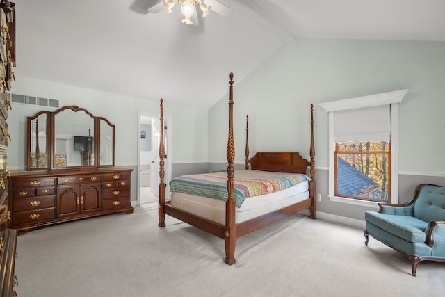 carpeted bedroom featuring vaulted ceiling with beams, ensuite bathroom, and ceiling fan