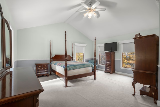 carpeted bedroom featuring ceiling fan and lofted ceiling with beams