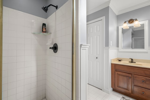 bathroom featuring tile patterned floors, vanity, a tile shower, and ornamental molding