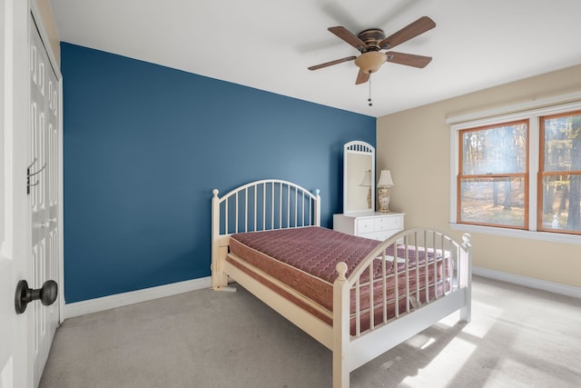 bedroom with light carpet, a closet, and ceiling fan