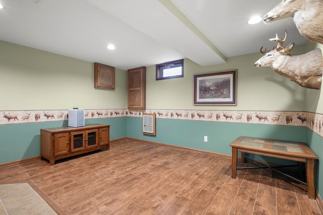 interior space with hardwood / wood-style floors and heating unit