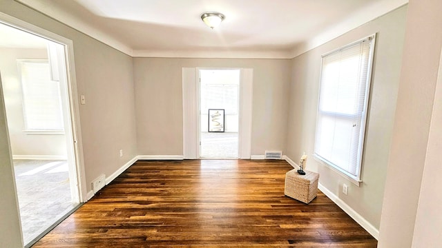 spare room featuring dark hardwood / wood-style flooring