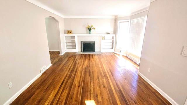 unfurnished living room with dark hardwood / wood-style flooring and a fireplace