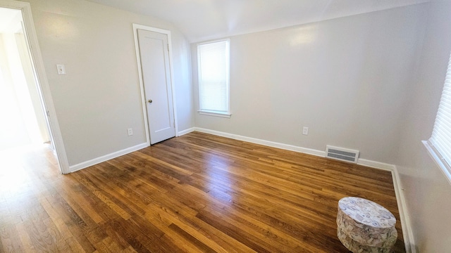 unfurnished room featuring dark wood-type flooring