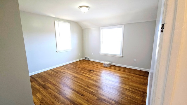 bonus room featuring dark hardwood / wood-style floors and lofted ceiling