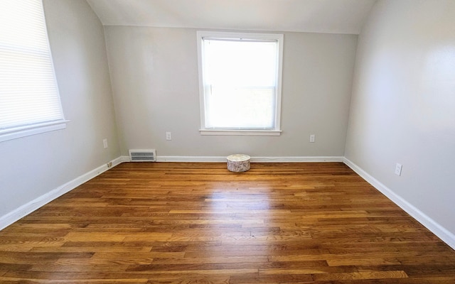 empty room with dark wood-type flooring