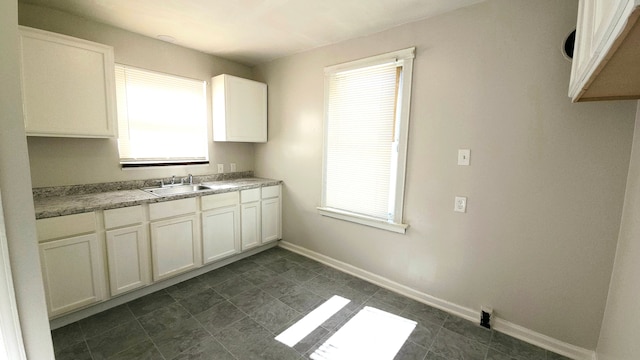 kitchen featuring sink and white cabinets