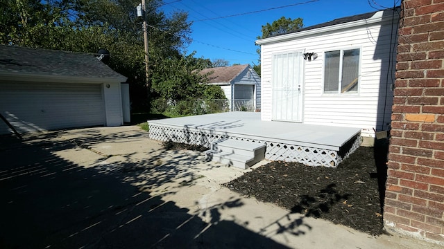 wooden terrace with a garage and an outdoor structure