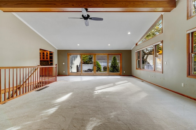 unfurnished living room with beamed ceiling, plenty of natural light, ceiling fan, and light carpet