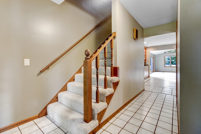 staircase featuring tile patterned floors