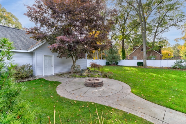 view of yard featuring an outdoor fire pit and a patio area