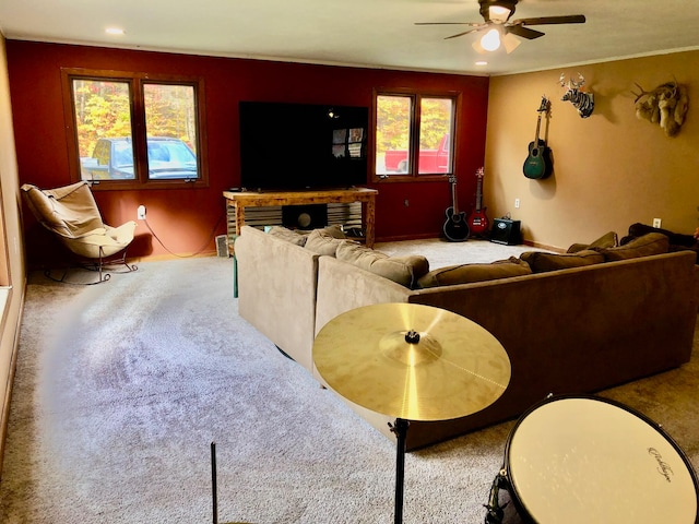 carpeted living room featuring plenty of natural light and ceiling fan