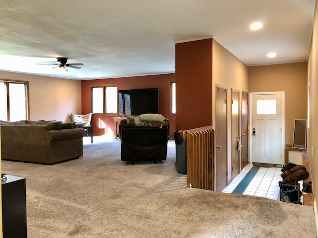 carpeted living room featuring ceiling fan