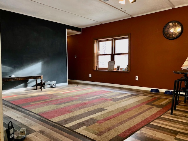 interior space with wood-type flooring and ceiling fan