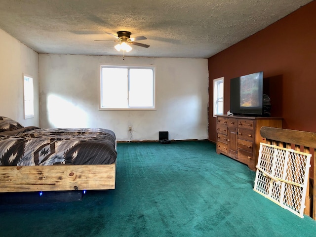 carpeted bedroom featuring ceiling fan and a textured ceiling