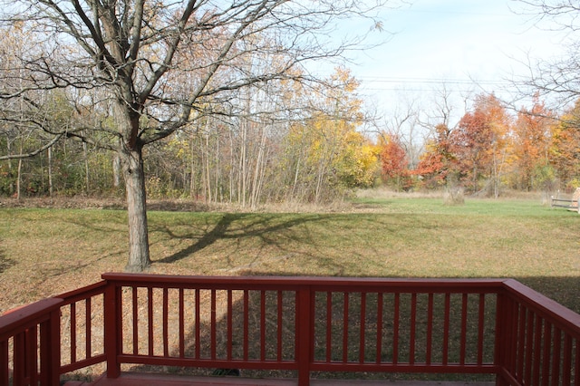 wooden terrace with a lawn