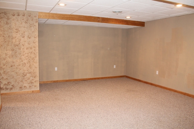 carpeted spare room with a paneled ceiling