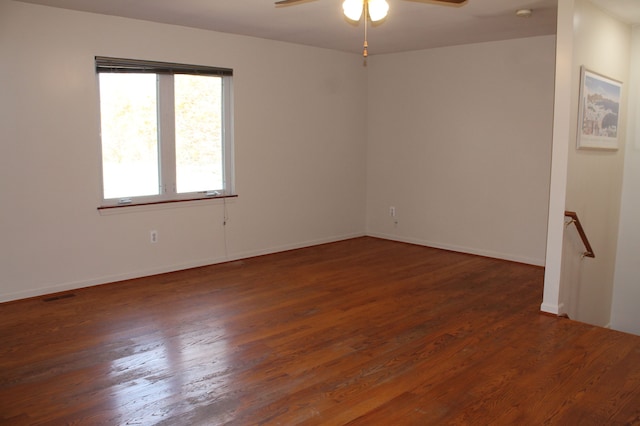 empty room with dark hardwood / wood-style floors and ceiling fan