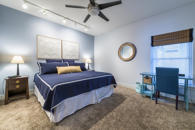 bedroom with ceiling fan, carpet floors, and track lighting