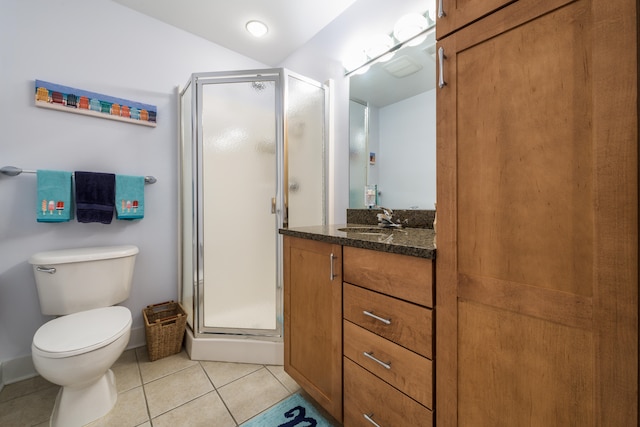 bathroom with tile patterned flooring, vanity, toilet, and walk in shower