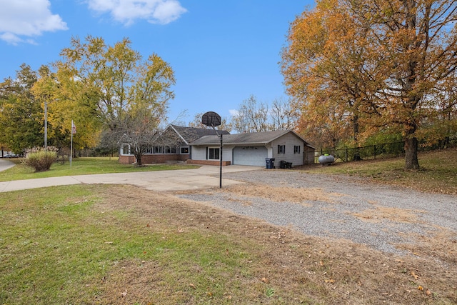 ranch-style house with a garage and a front yard