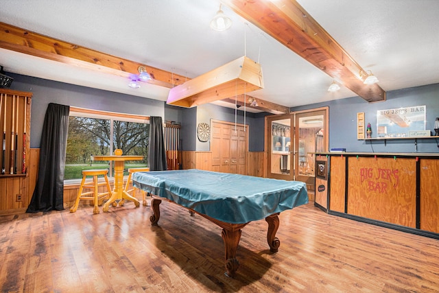 rec room featuring beam ceiling, wood walls, light hardwood / wood-style flooring, and pool table