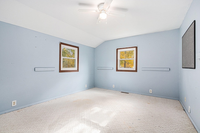 empty room featuring ceiling fan and lofted ceiling