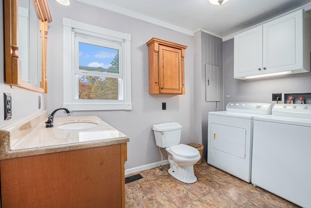 laundry room featuring crown molding, sink, and washing machine and clothes dryer