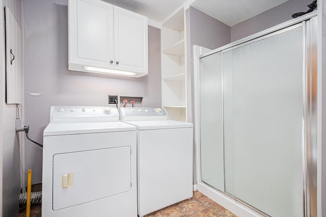 laundry area with washer and dryer and cabinets