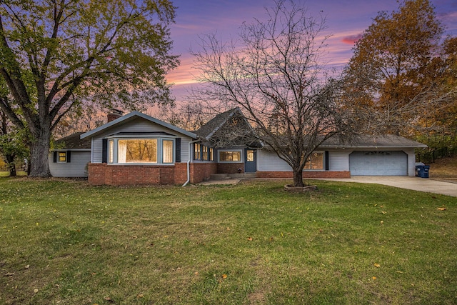 ranch-style home with a yard and a garage