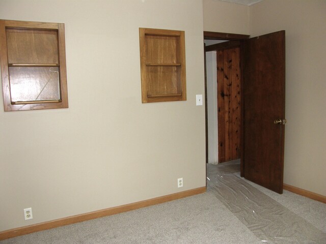 unfurnished room with light colored carpet