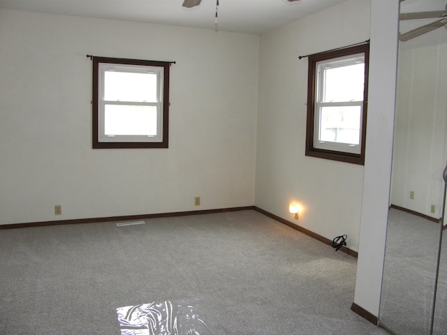 unfurnished room with ceiling fan and light colored carpet