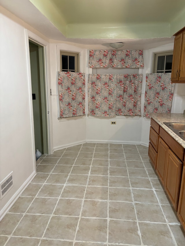 kitchen featuring light tile patterned flooring and sink