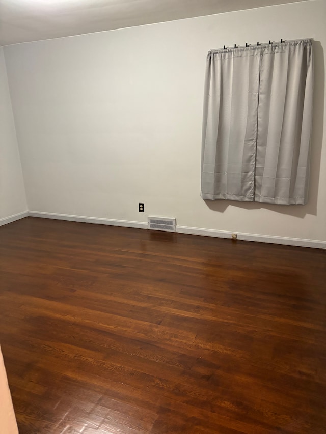 spare room featuring dark hardwood / wood-style floors