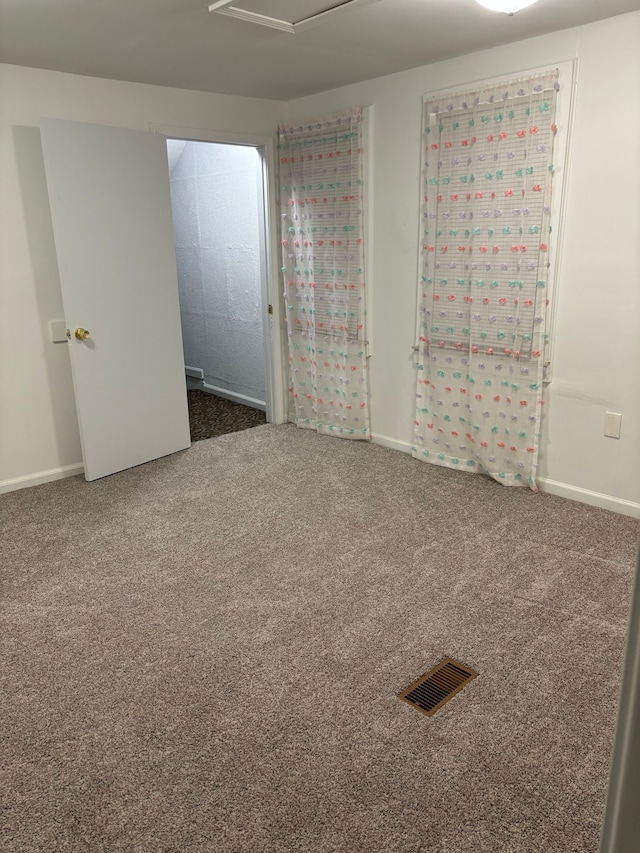 unfurnished room featuring dark colored carpet