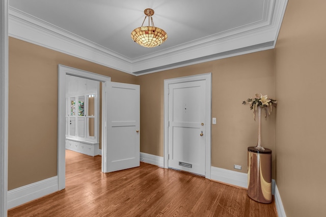 entryway featuring hardwood / wood-style floors and ornamental molding