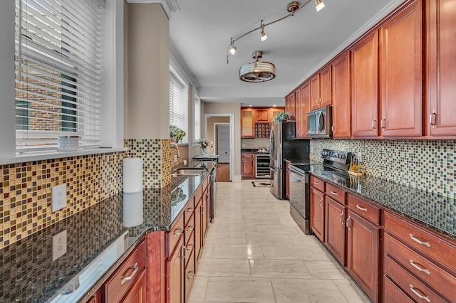 kitchen with tasteful backsplash, black range with electric stovetop, and dark stone countertops