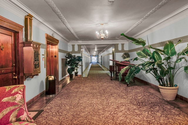 hall featuring elevator, dark tile patterned floors, a chandelier, and ornamental molding