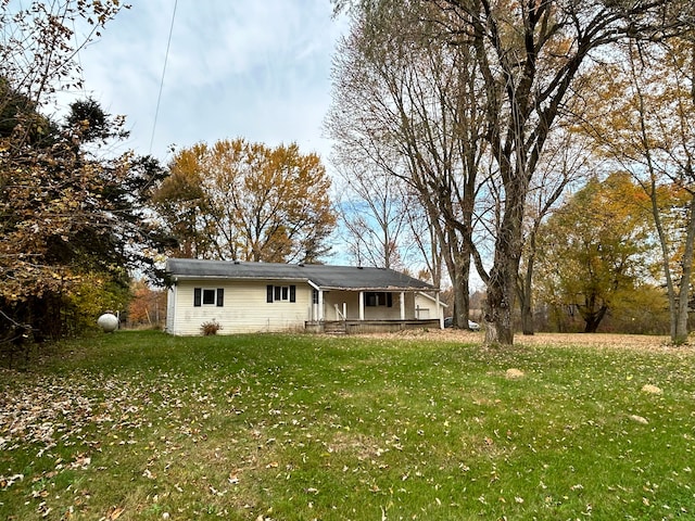 back of property with a lawn