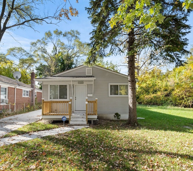 bungalow-style house featuring a front yard