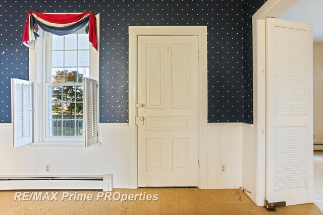 10300 Lange Rd, Birch Run, MI 48415 - foyer entrance with a baseboard radiator, wallpapered walls, carpet floors, and a wainscoted wall