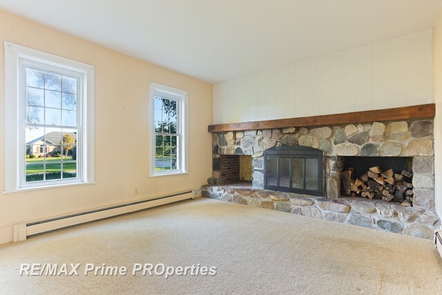 10300 Lange Rd, Birch Run, MI 48415 - unfurnished living room featuring a baseboard heating unit, a fireplace, and carpet