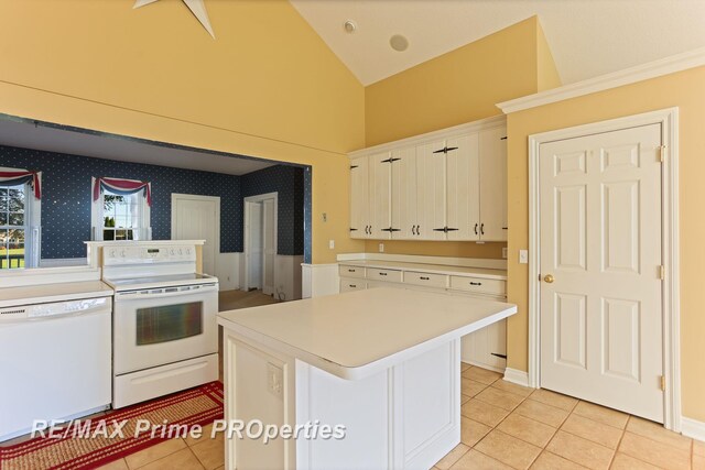 10300 Lange Rd, Birch Run, MI 48415 - kitchen with white appliances, light tile patterned flooring, light countertops, white cabinetry, and high vaulted ceiling