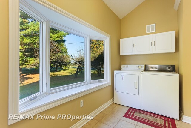 10300 Lange Rd, Birch Run, MI 48415 - laundry area with cabinet space, washer and clothes dryer, baseboards, and light tile patterned flooring